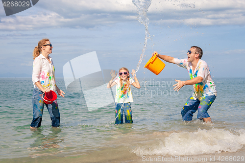 Image of Happy family playing on the beach at the day time.