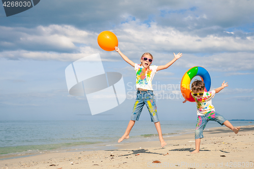 Image of Happy children playing on the beach at the day time.