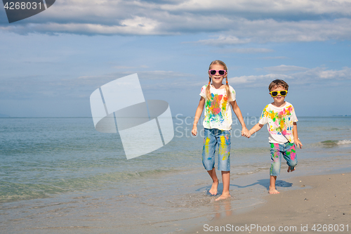 Image of Happy children playing on the beach at the day time.