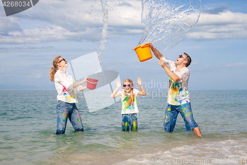 Image of Happy family playing on the beach at the day time.