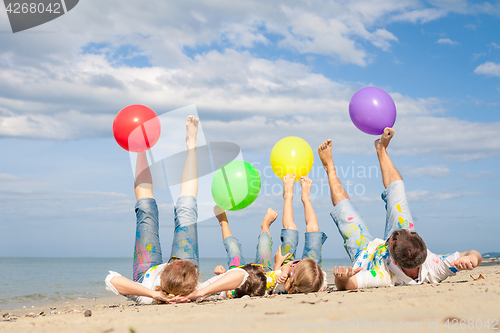 Image of Happy family playing on the beach at the day time.