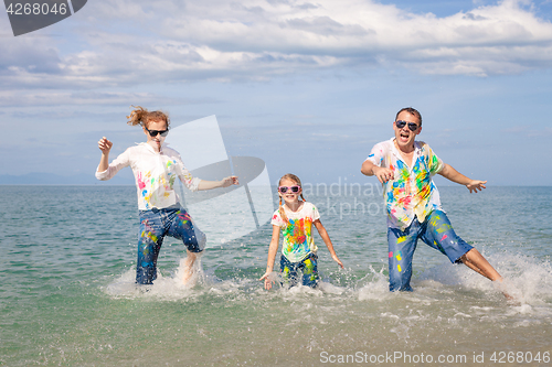 Image of Happy family playing on the beach at the day time.