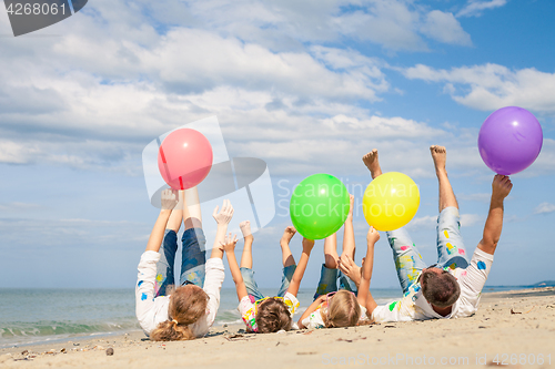Image of Happy family playing on the beach at the day time.