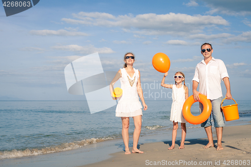 Image of Happy family playing on the beach at the day time.