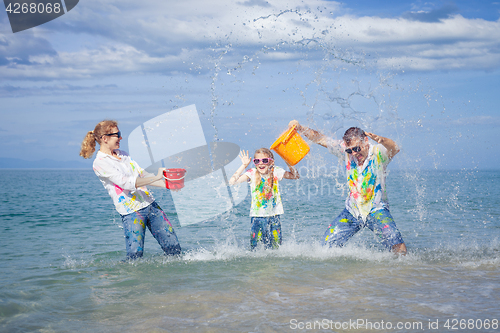 Image of Happy family playing on the beach at the day time.