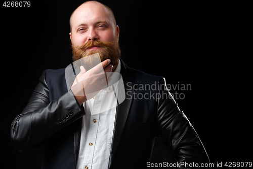 Image of Man stroking his ginger beard