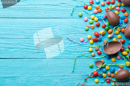 Image of Multi-colored sweets, chocolate eggs, ribbon