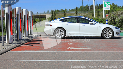 Image of White Tesla Model S Electric Car Charging Battery