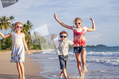 Image of Happy children playing on the beach at the day time.