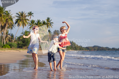 Image of Happy family playing on the beach at the day time.