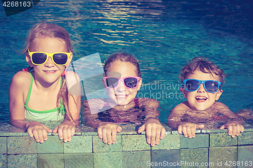 Image of happy children  playing on the swimming pool at the day time