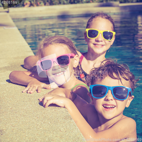 Image of happy children  playing on the swimming pool at the day time