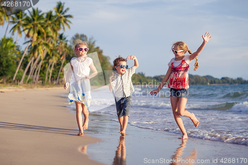 Image of Happy children playing on the beach at the day time.