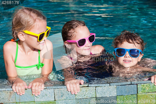 Image of happy children  playing on the swimming pool at the day time