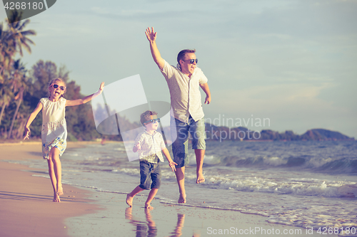 Image of Happy children playing on the beach at the day time.