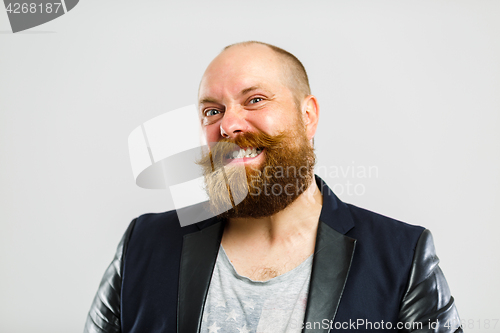 Image of Laughing brutal man with beard