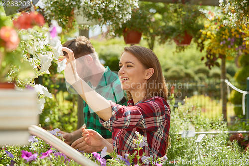 Image of Man and woman with flowers in garden