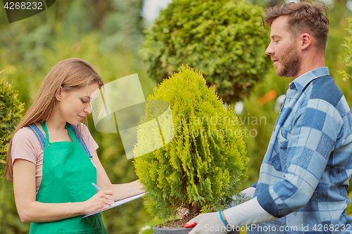 Image of Gardeners working with papers