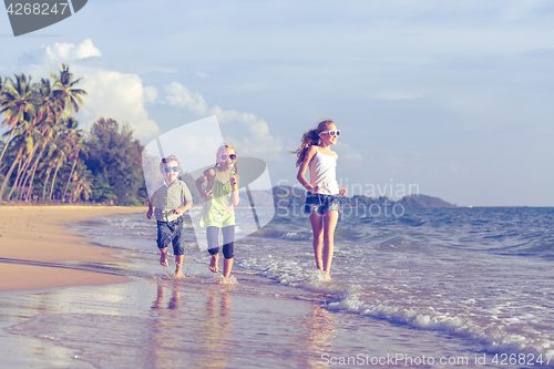 Image of Happy children playing on the beach at the day time.