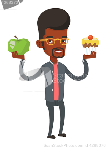 Image of Man choosing between apple and cupcake.