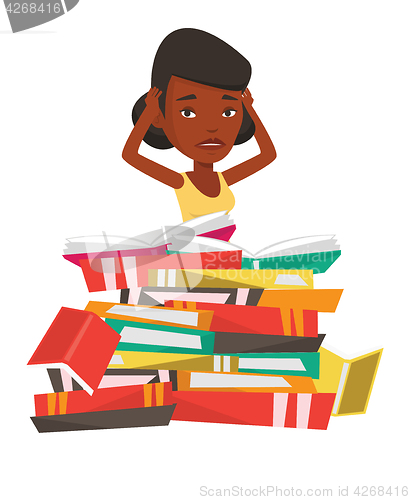 Image of Student sitting in huge pile of books.