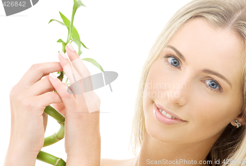 Image of happy blonde with bamboo