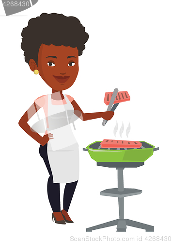 Image of Woman cooking steak on barbecue grill.