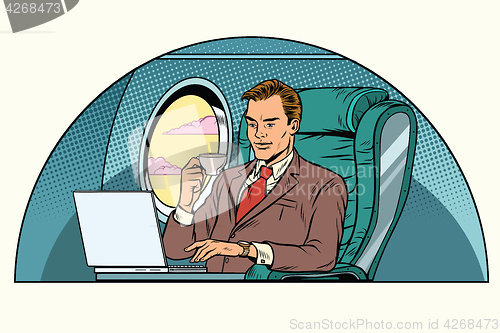 Image of businessman working in the business class cabin