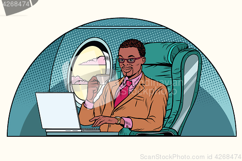 Image of businessman working in the business class cabin