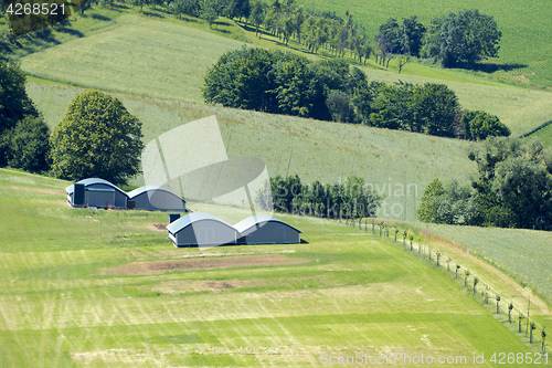 Image of huts in the green meadow