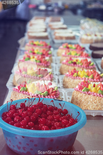 Image of Bowl of cherry on cake production