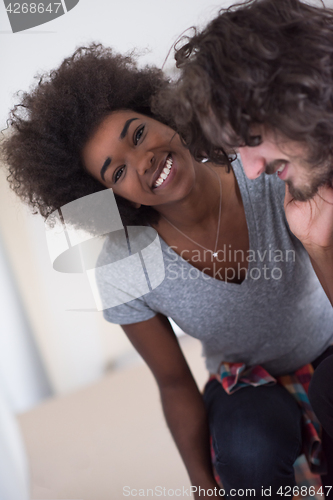 Image of multiethnic couple renovating their home