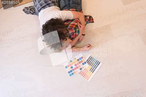 Image of Happy young couple relaxing after painting