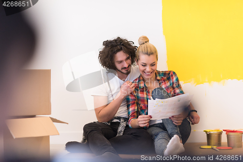 Image of Happy young couple relaxing after painting