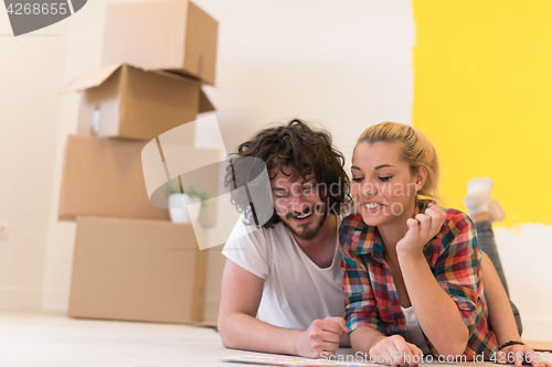 Image of Happy young couple relaxing after painting