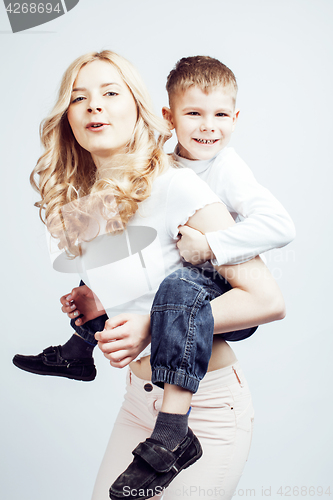 Image of young modern blond curly mother with cute son together happy smiling family posing cheerful on white background, lifestyle people concept, sister and brother friends