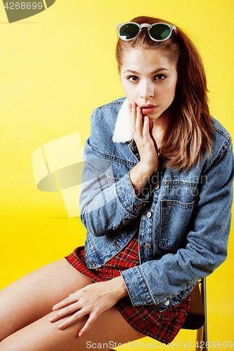 Image of lifestyle people concept: pretty young school teenage girl having fun happy smiling on yellow background