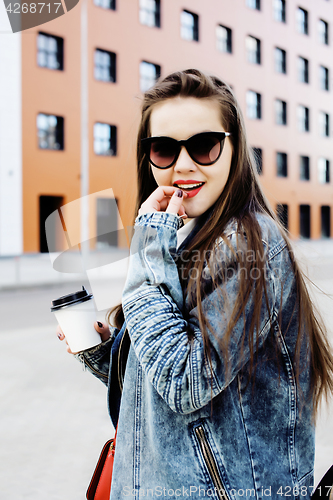 Image of young pretty hipster girl student with coffee cup posing adorable smiling, lifestyle people concept outdoor