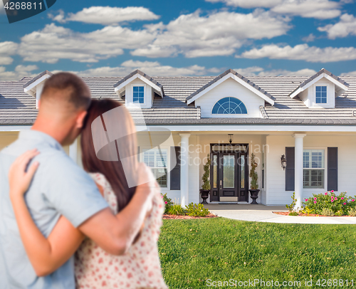 Image of Young Military Couple Facing Beautiful New House.