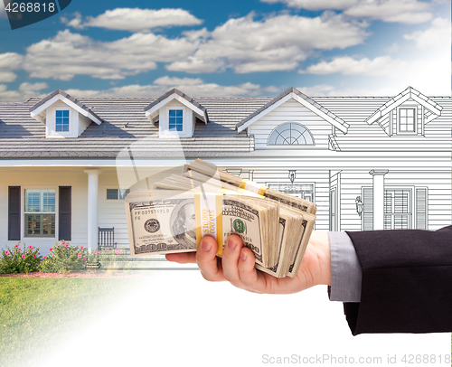 Image of Hand Holding Stack of Money Over House Drawing Gradating Into Ph