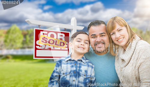 Image of Mixed Race Family In Front of House and Sold For Sale Real Estat