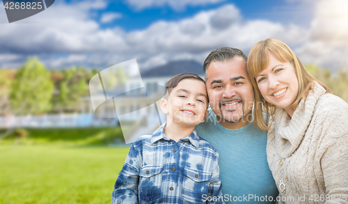Image of Mixed Race Family In Front Yard of Beautiful House and Property.