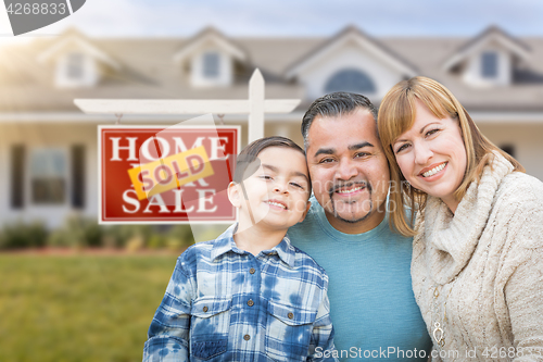 Image of Mixed Race Family In Front of House and Sold For Sale Real Estat
