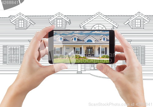 Image of Hands Holding Smart Phone Displaying Home Photo of Drawing Behin