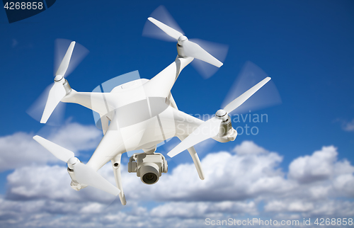 Image of Unmanned Aircraft System (UAV) Quadcopter Drone In The Air.