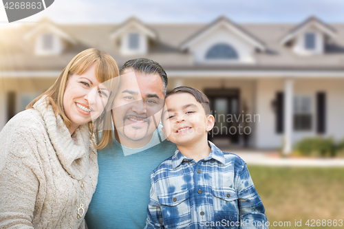 Image of Mixed Race Family In Front Yard of Beautiful House and Property.