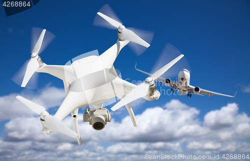 Image of Unmanned Aircraft System (UAV) Quadcopter Drone In The Air Too C