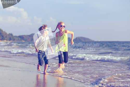 Image of Happy children playing on the beach at the day time.