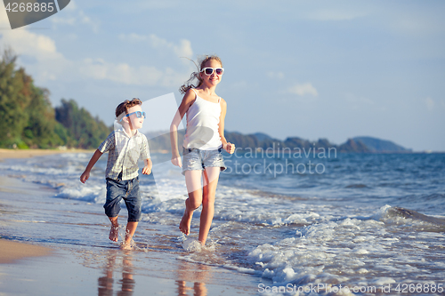 Image of Happy children playing on the beach at the day time.