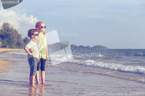 Image of Happy children playing on the beach at the day time.